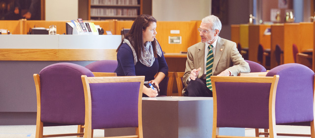 student and mentor in library