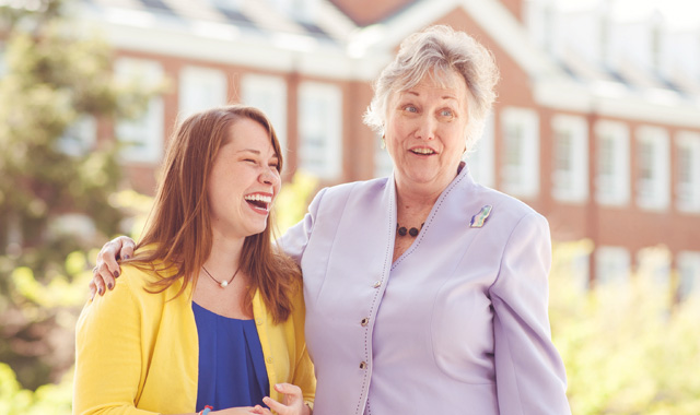 Student laughing with mentor