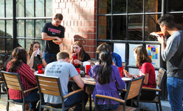 students at a cafe eating pizza