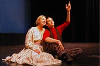 Julie (Sarah Elizabeth Billiter) and Billy (Cameron Perry) enjoy the falling spring blossoms against a starry night, as each speculates on what it would be like to love the other, singing “If I Loved You.”
