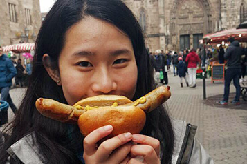 student enjoying a sausage