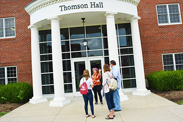 Students in front of a residence hall