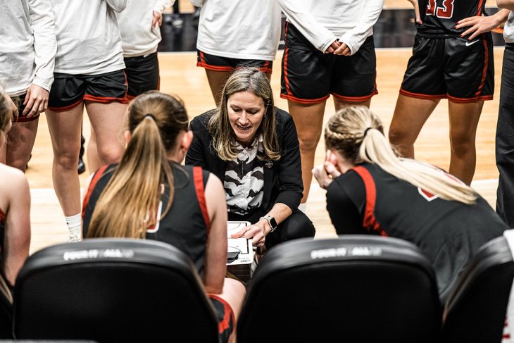 Coach Juli Fulks gives feedback to her team in the midst of the game.