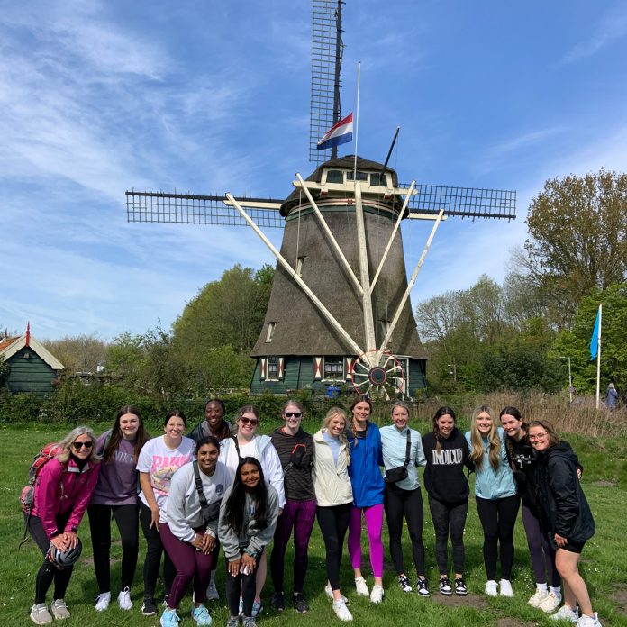 Students in front of a windmill in the Netherlands as part of their May term class.