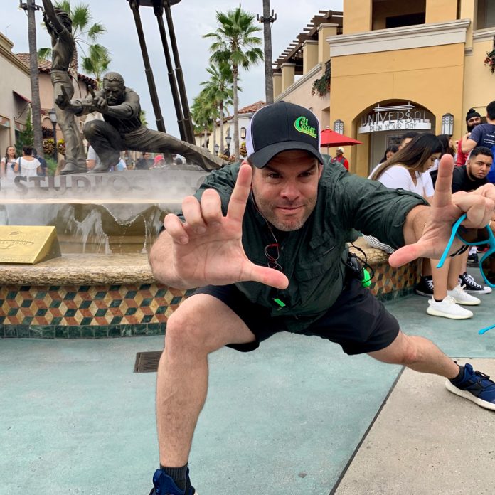 Hayden Mauk poses in front of the director fountain at Universal Studios Hollywood.