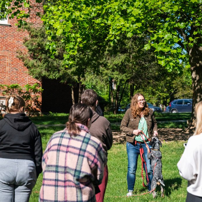 Professor Ellen Furlong and her dog, Olive, demonstrate how to take a "sniffy walk" to students in Furlong's "What Does Fido Know?" May term class.
