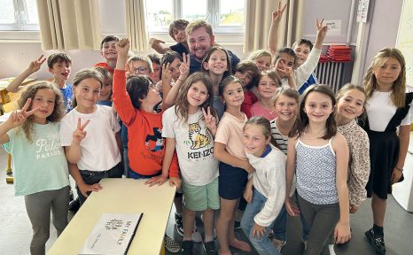 transy alum surrounded by class of school students