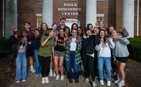 group of students standing in front of poole residence center