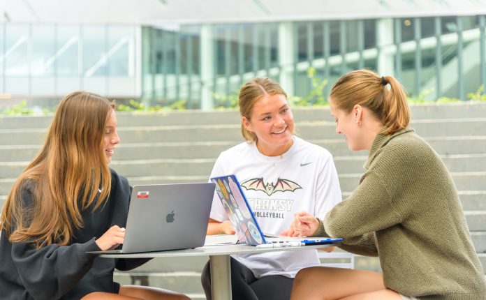 Transylvania University students having a discussion at an outdoor table