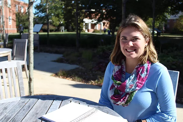 writing center staffer at outdoor table